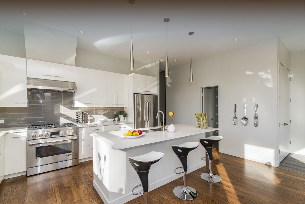 A kitchen with white cabinets - Castle Property Services - red ash removal in Newcastle Staffordshire
